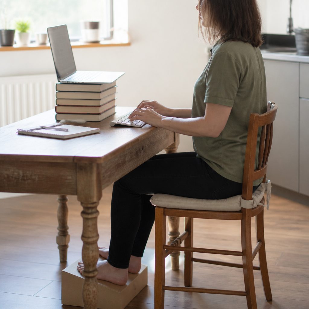 A kitchen table cleared into a temporary workstation.
